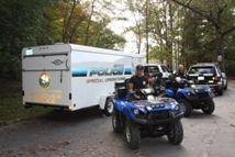 Police officers riding ATVs.