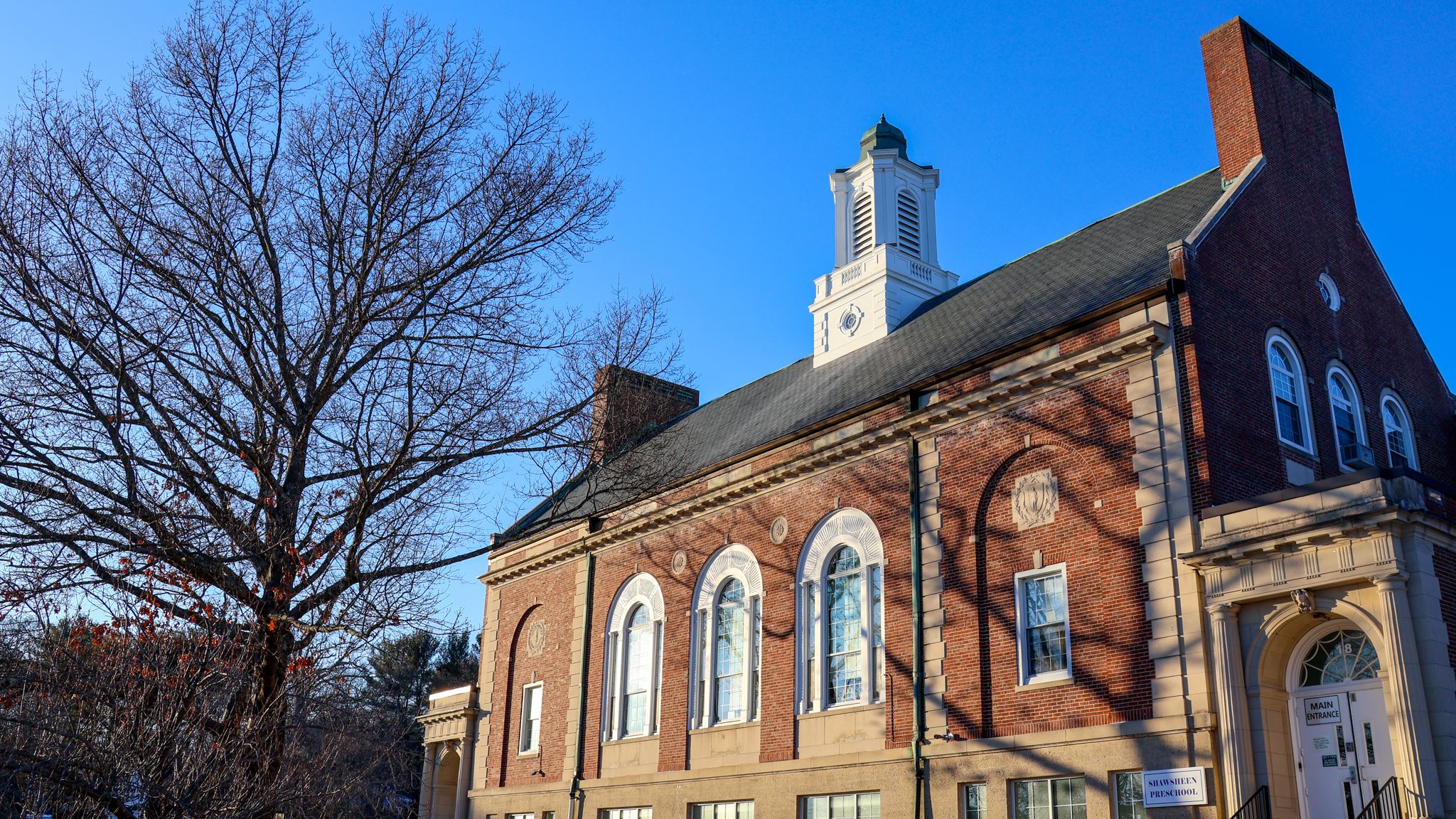 The exterior of the Shawsheen School, a large brick structure.